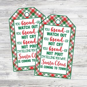 May include: Two Christmas gift tags with a plaid border in red, green, and white. The tags have a white background with the text "YOU bread-er WATCH OUT YOU bread-er NOT CRY YOU bread-er NOT POUT I'M TELLING YOU Santa Claus IS COMING TO TOWN!"