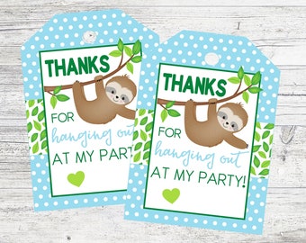 May include: Two blue and white polka dot favour tags with a green sloth hanging from a branch. The tags say "Thanks for hanging out at my party!"