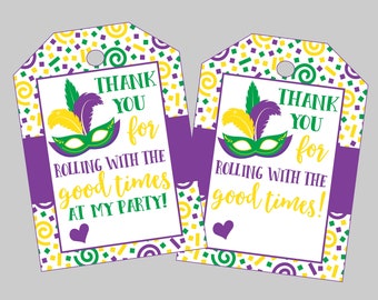 May include: Two purple and white thank you tags with a Mardi Gras theme. The tags feature a green, gold, and purple mask with feathers, confetti, and the text "Thank you for rolling with the good times at my party!"