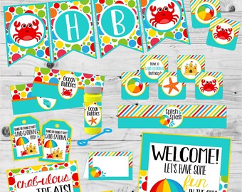 May include: A set of printable party decorations for a beach-themed birthday party. The decorations feature a crab, an umbrella, a sandcastle, and the words "Sand-Sational Birthday".