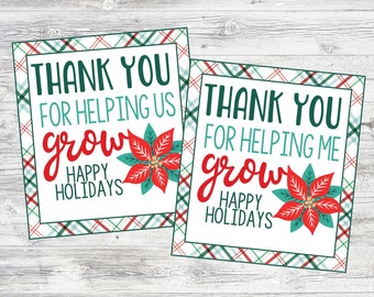 May include: Two printable gift tags with a red poinsettia and plaid background. The text on the tags reads "Thank you for helping us grow" and "Thank you for helping me grow". Both tags include the phrase "Happy Holidays".
