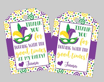 May include: Two purple and white favor tags with a Mardi Gras theme. The tags feature a gold and green mask, confetti, and the text "Thank you for rolling with the good times at my party!" with the name "Jiana".