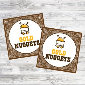 May include: Two brown and white paisley patterned square cards with a white circle in the center. The circle contains a yellow cartoon image of a mine cart filled with gold nuggets. The text "GOLD NUGGETS" is printed in black below the image.