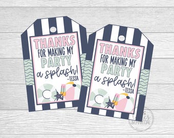May include: Two navy blue and white striped gift tags with the text "THANKS FOR MAKING MY PARTY a splash!" in pink and black. The tags have a beach theme with illustrations of a beach ball, starfish, and a drink.