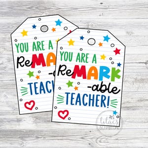 May include: Two white gift tags with a black outline and colorful stars. The text on the tags reads "You are a Remarkable Teacher!"