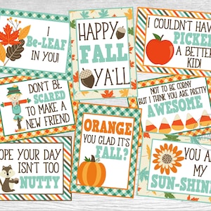 May include: Nine colorful cards with fall-themed puns and illustrations. The cards feature a scarecrow, a squirrel, a pumpkin, a sunflower, an apple, candy corn, and fall leaves. The text on the cards includes phrases like "Be-Leaf in You!" and "Happy Fall Y'all!"