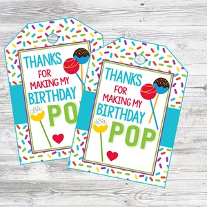 May include: Two colorful thank you tags with a sprinkle pattern background. The tags feature a cake pop graphic and the text "Thanks for making my birthday pop".
