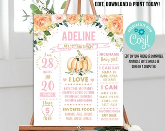 May include: A pink and gold printable first birthday poster with a pumpkin and floral design. The poster includes the name "Adeline", the age "1", and details about the child's growth and development. It says "I am 28 inches and 20 pounds. I have 5 teeth. I love bath time, my family, clapping, going outside, swimming, dancing, mommy and daddy. Favorite foods: bananas, peas, yogurt, pasta, bread, apples. I can say mama, hi, dada, baba, no, baby. I can walk, clap, wave bye bye, stand, hi5, give hugs. Favorite songs: Baby Shark, Wheels on the Bus."