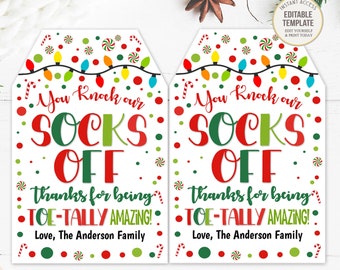May include: Two white Christmas gift tags with the text "You knock our socks off" in red and green. The tags have a string of colorful lights and candy cane accents. The text "Thanks for being toe-tally amazing!" is also included.