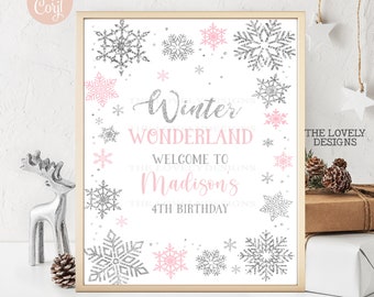 May include: A printable sign for a winter wonderland themed birthday party. The sign is white with pink and silver glitter snowflakes and the text "Winter Wonderland Welcome to Madison's 4th Birthday".