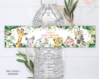 May include: Water bottle label with a jungle theme. The label features a giraffe, elephant, lion, monkey, and zebra with floral crowns. The text on the label reads "Sophia's Baby Shower 12-6-2021".