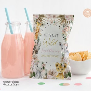 May include: Let's Get Wild!  A pink and gold party favor bag with a jungle animal theme. The bag features a giraffe, zebra, rhino, elephant, and lion. The text on the bag reads "Let's Get Wild! Hazel Marie's 2nd Birthday".