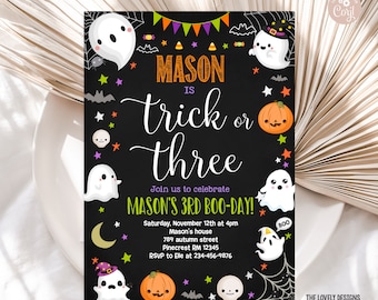 May include: Black and white chalkboard style invitation with a ghost and pumpkin theme. The text reads "Mason is trick or three. Join us to celebrate Mason's 3rd Boo-Day! Saturday, November 12th at 4pm Mason's house 789 autumn street Pinecrest RM 12345 RSVP to Elle at 234-456-9876"