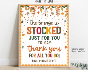 May include: A framed print with a fall theme. The text reads "The lounge is STOCKED JUST FOR YOU TO SAY thank you FOR ALL YOU DO!" in orange, green, and brown. The frame has a yellow and orange checkered border.