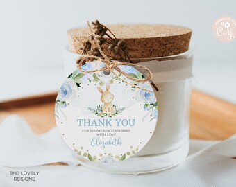 May include: A round thank you tag with a blue and white floral design, a small bunny illustration, and the text "THANK YOU FOR SHOWERING OUR BABY WITH LOVE Elizabeth".