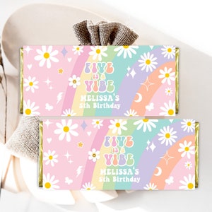 May include: Two candy bar wrappers with a pastel rainbow, daisies, and the text "FIVE IS A VIBE, MELISSA'S 5th Birthday." The wrappers have a retro, groovy design with stars, moons, and lightning bolts.