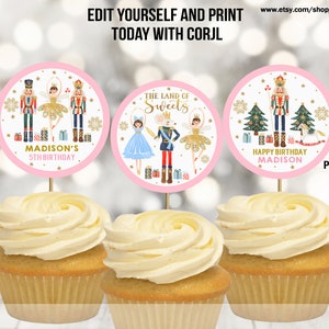 May include: Three round cupcake toppers featuring a Nutcracker theme. The toppers are pink with gold accents and feature a ballerina, a Nutcracker, and a Christmas tree. The text on the toppers reads "Madison's 5th Birthday", "The Land of Sweets", and "Happy Birthday Madison".
