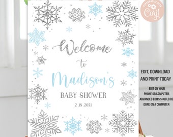 May include: Welcome to Madison's Baby Shower sign with a silver glitter snowflake design and blue snowflakes. The date of the shower is 2.18.2021.