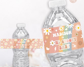May include: Water bottle label with a rainbow, daisies, and the text "Madison is one groovy baby".