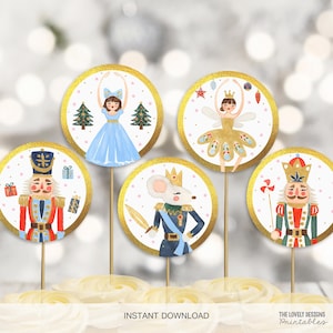 May include: Set of six round, gold-rimmed cupcake toppers featuring illustrations of characters from the Nutcracker ballet. The toppers include a ballerina, a nutcracker soldier, a mouse king, and a sugar plum fairy.