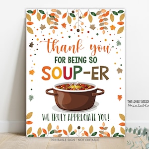 May include: A rectangular sign with a white background and fall-themed decorations. The sign features the text "Thank you for being so soup-er! We truly appreciate you!" A brown pot of soup is in the center. The sign is a printable design.