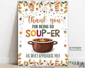 May include: A rectangular sign with a white background and fall-themed decorations. The sign features the text "Thank you for being so soup-er! We truly appreciate you!" A brown pot of soup is in the center. The sign is a printable design.