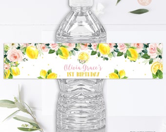 May include: Water bottle label with a lemon and floral design. The label says "Olivia Grace's 1st Birthday".