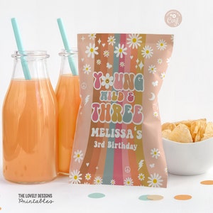 May include: A pink and orange party favor bag with a rainbow and daisy pattern. The bag has the text "Young Wild & Three Melissa's 3rd Birthday" printed on it.