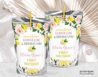 May include: Two silver juice pouch boxes with labels featuring a floral design with lemons and the text "sunshine lemonade & birthday fun!" and "Olivia Grace's First Birthday".