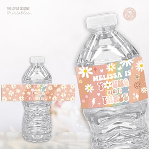 May include: Water bottle label with a rainbow, daisies, and the text "Melissa is turning three, wild & three".