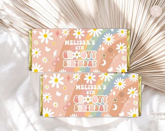May include: Two printable chocolate bar wrappers with a pink background and a rainbow design. The wrappers feature daisies, peace signs, stars, and the text "Melissa's 8th Groovy Birthday".