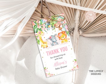 May include: Pink and gold thank you tag with a jungle theme. The tag features a giraffe, elephant, lion, and monkey. The text on the tag reads "Thank you for showering us with love Allison's Baby Shower".