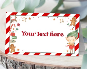 May include: Red and white striped place card with a gingerbread man, a reindeer, and a candy cane on the left side. The right side features a cartoon elf with a green hat and red shirt. The text "Your text here" is in the center of the card.