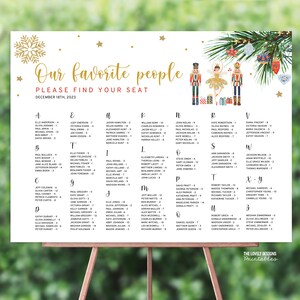 May include: A white printable seating chart with a gold snowflake and stars. The chart is decorated with a Nutcracker and ballerina illustration. The text reads "Our favorite people, Please find your seat, December 18th, 2023".