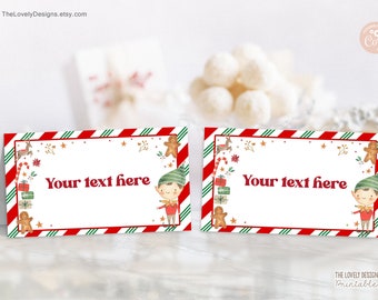 May include: Two printable Christmas place cards featuring a red and green striped background with a white centre. The centre features a cartoon elf holding a candy cane and a gingerbread man. The text "Your text here" is printed in red on the white centre.