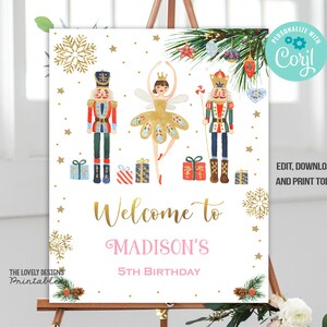 May include: A white welcome sign with watercolor illustrations of a ballerina, two nutcrackers, and wrapped gifts. The sign reads "Welcome to Madison's 5th Birthday" in gold and pink lettering. The sign is decorated with gold snowflakes and stars.