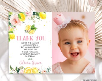 May include: A pink and white thank you card with a lemon and floral design. The card says "Thank You" and includes the text "I loved the cake and my presents too, but my favorite part was seeing you. Thanks for making my 1st birthday party so special! Love, Olivia Grace". A photo of a baby girl wearing a pink crown is in the background.
