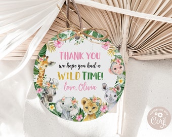 May include: Round thank you tag with a jungle theme. It features a giraffe, zebra, elephant, lion, and monkey surrounded by green leaves and pink flowers. The text reads "Thank you we hope you had a WILD TIME! love, Olivia".