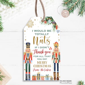 May include: A Christmas gift tag featuring two nutcracker illustrations. The tag has a white background with gold glitter and green and red baubles. The text reads "I would be totally nuts if I didn't thank you for all that you do! Merry Christmas from: the Carters".