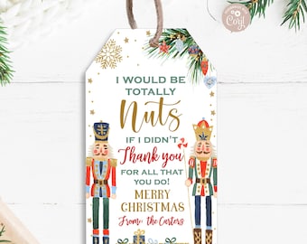 May include: A Christmas gift tag with two nutcracker illustrations. The tag has a white background with gold glitter and green and red ornaments. The text reads "I would be totally nuts if I didn't thank you for all that you do! Merry Christmas from: the Carters".