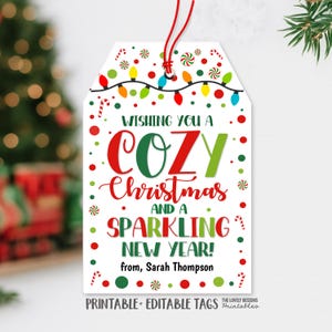 May include: A white printable Christmas gift tag with a red string. The tag features the text "Wishing You a Cozy Christmas and a Sparkling New Year!" in red and green. Decorative elements include candy canes and Christmas lights.