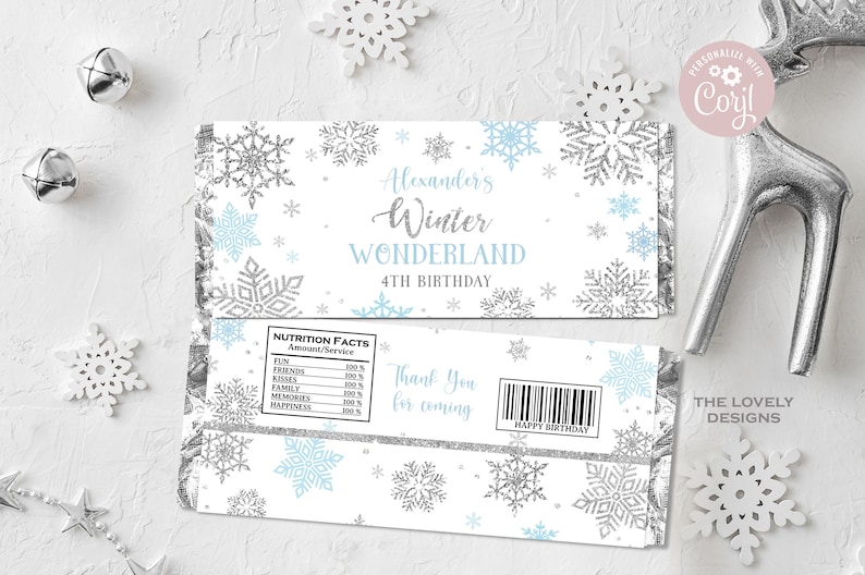 May include: A white chocolate bar wrapper with a winter wonderland theme. It features a blue and silver snowflake design with the text "Alexander's Winter Wonderland 4th Birthday". The back of the wrapper has a nutrition facts label and a thank you for coming message.