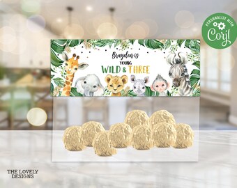 May include: A printable favor bag topper with a jungle theme. The topper features a giraffe, elephant, lion, rhino, and monkey. The text reads "Brayden is young, Wild & Three".