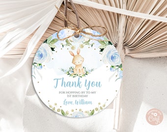 May include: Round blue and white thank you tag with a watercolor floral design and a small bunny illustration. The tag says "Thank you for hopping by to my 1st birthday. Love, William."