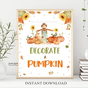 May include: Printable sign with a watercolor illustration of a scarecrow standing in front of pumpkins. The sign says "Decorate a Pumpkin" with fall-themed decorations around the border.