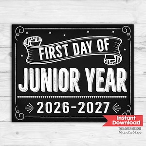 May include: A black rectangular sign with white text and decorative borders. The text reads FIRST DAY OF JUNIOR YEAR 2026-2027. The design features a banner graphic across the top and small stars scattered throughout the chalkboard-style background.