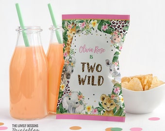 May include: Pink and green party favor bag with a jungle animal theme. The bag has a white background with a pink border and gold glitter text that says "Olivia Rose is Two Wild".