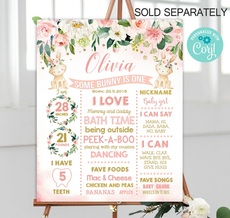 May include: Pink and green floral first birthday sign featuring a bunny rabbit illustration. The sign reads "Olivia Some Bunny is One" and includes details about the child's age, height, weight, favourite foods, and songs.