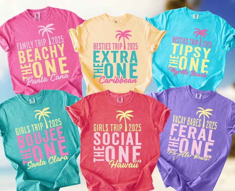 May include: Six short-sleeved crew neck t-shirts in pink, yellow, light blue, teal, coral, and purple. Each shirt features a palm tree graphic, the year 2025, and text including phrases like Beachy The One, Extra The One, Tipsy The One, and Feral The One.