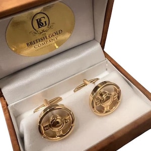 May include: Gold cufflinks in a brown velvet box with the text "The British Gold Company" on the lid.